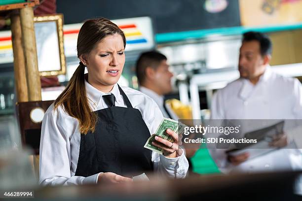 waitress in tex-mex restaurant disappointed in small tip from customer - miserly stock pictures, royalty-free photos & images