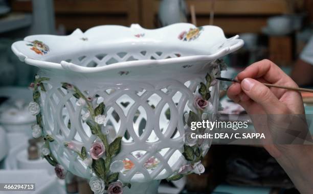 Painting porcelain decorations, Herend factory, Hungary.