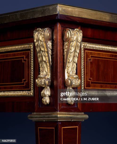 Louis XVI style Second Empire writing desk with amaranth and satinwood veneer finish and inlays. France, 19th century. Detail of bronze band around...