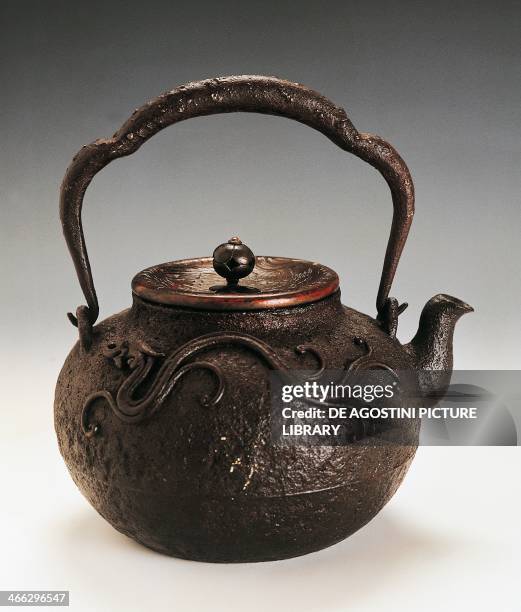 Tetsubin tea pot, 19th century, cast iron with handle, with relief application depicting a stylized dragon, height 20.8 cm. Japanese civilisation,...