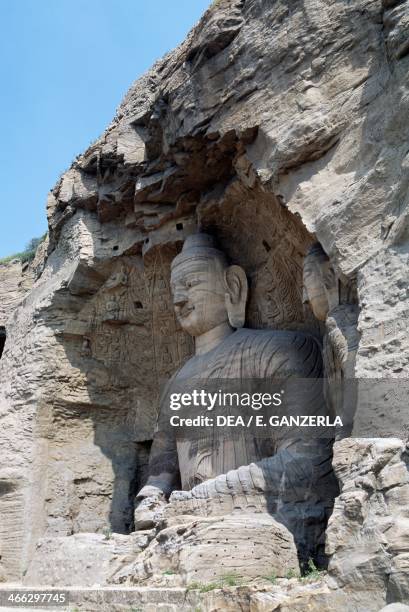 Statue of Buddha in cave No. 20, carved in the sandstone between 453 and 525 AD, iconographic features typical of Northern Wei art, Yungang grottoes...