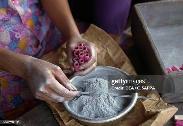 Female factory worker making firecrackers, near Da Nang, Vietnam.