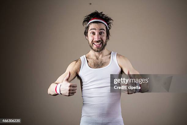 funny sports nerd posing with thumbs up - aerobic stockfoto's en -beelden