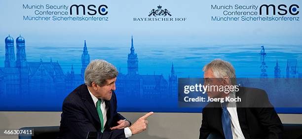 Secretary of State John Kerry and US Secretary of Defense Chuck Hagel talk during the 50th Munich Security Conference at the Bayerischer Hof hotel on...