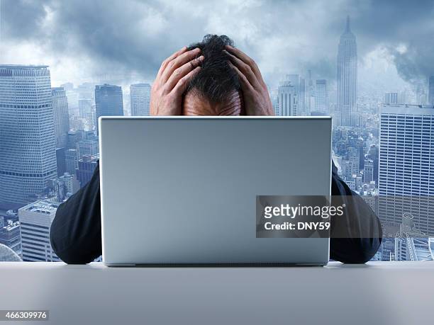 frustrated businessman in front of laptop computer - futility stock pictures, royalty-free photos & images