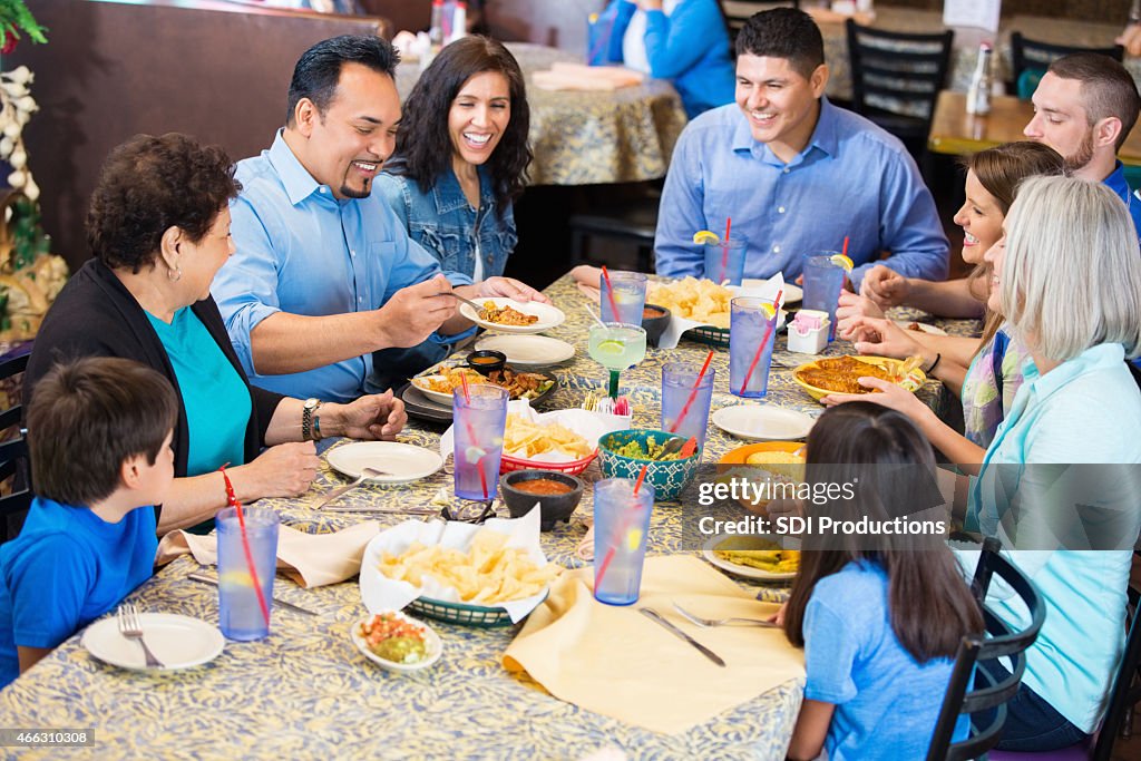 Large extended family having meal together in Mexican restaurant