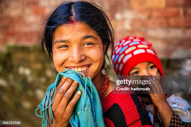 young mother carrying her baby, kathmandu, nepal - nepal culture stock pictures, royalty-free photos & images