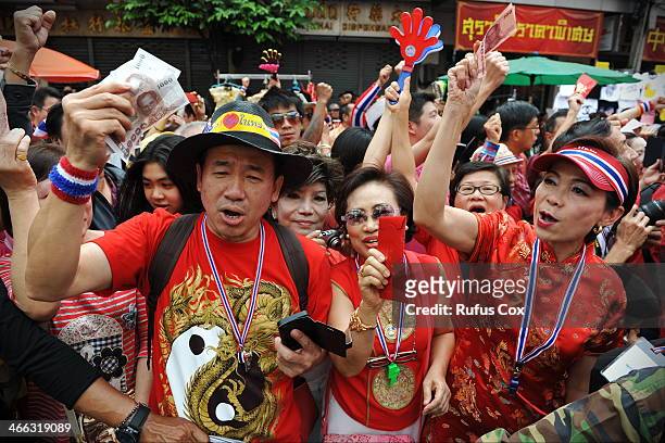 Anti-government protesters wait to give cash donations to protest Suthep Thaugsuban during a rally through Chinatown on February 1, 2014 in Bangkok,...