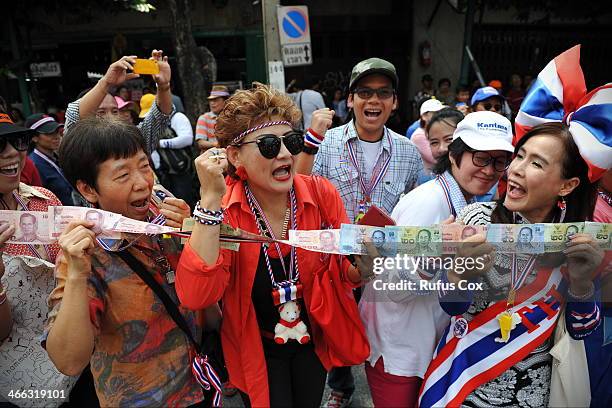 Anti-government protesters chant slogans while waiting to give cash donations to protest Suthep Thaugsuban during a rally through Chinatown on...