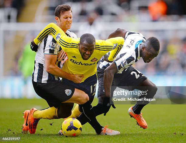 Jozy Altidore of Sunderland is brought down by Michael Williamson and Cheik Ismael Tiote of Newcastle during the Barclays Premier League match...