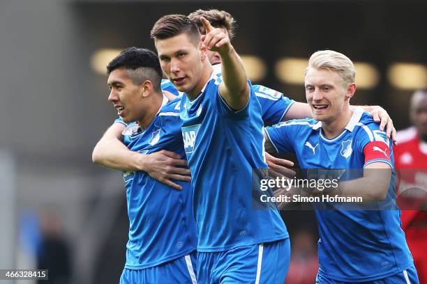 Roberto Firmino of Hoffenheim celebrates his team's first goal with his team mates Niklas Suele and Andreas Beck during the Bundesliga match between...