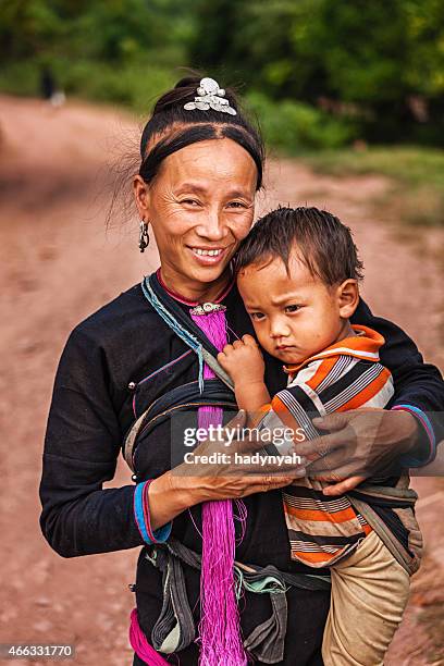 woman from the hill tribe carrying her baby - akha woman stock pictures, royalty-free photos & images