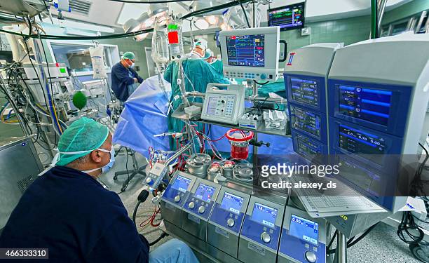 doctor checks data of cardiopulmonary bypass machine - long term stockfoto's en -beelden