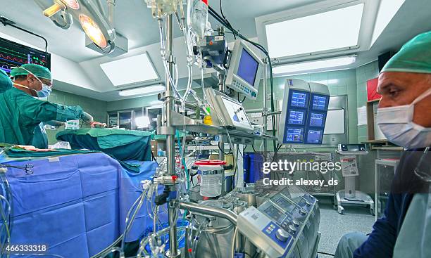 doctor checking out data of cardiopulmonary bypass machine - cardiopulmonary system stock pictures, royalty-free photos & images