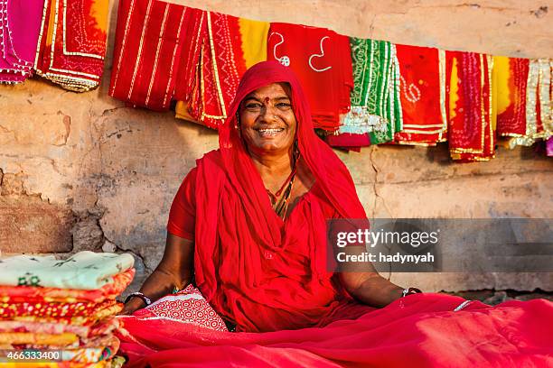 indian woman selling colorful fabrics - indian shopkeeper stock pictures, royalty-free photos & images