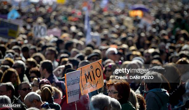 People hold a placards reading "Mine" during a protest against a reform of the country's abortion law proposed by the conservative Spanish...