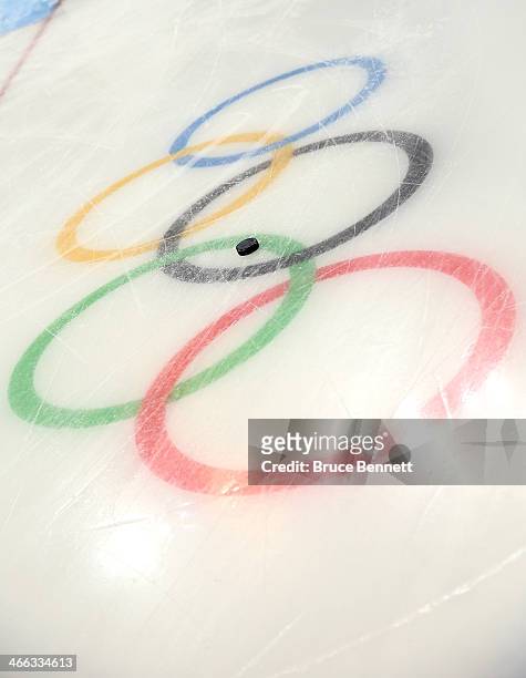 Puck sits on the Olympic rings logo during a women's hockey practice session prior to the Sochi 2014 Winter Olympics at the Shayba Arena on February...