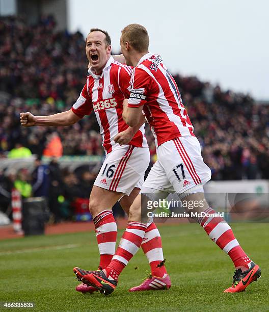 Charlie Adam of Stoke City celebrates scoring the opening goal with Ryan Shawcross during the Barclays Premier League match between Stoke City and...