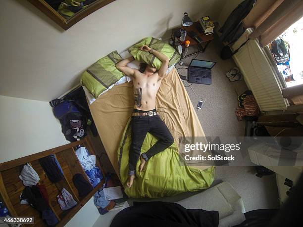 young man unconscious on bed - throwing up stock pictures, royalty-free photos & images