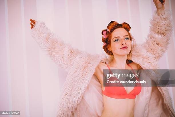 young woman being silly in underwear and fur coat - bra stock pictures, royalty-free photos & images