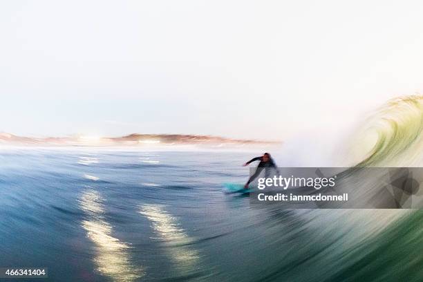evening surf - wetsuit stock pictures, royalty-free photos & images
