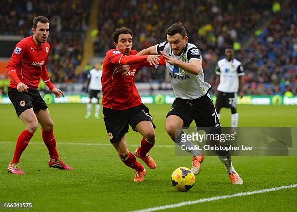 Robert Snodgrass of Norwich City takes on Fabio da Silva of Cardiff City during the Barclays Premier League match between Cardiff City and Norwich...