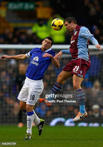Gareth Barry of Everton in action with Grant Holt of Aston Villa during the Barclays Premier League match between Everton and Aston Villa at Goodison...