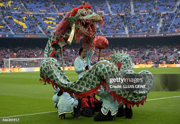 Artists dance with a Chinese dragon on the pitch to celebrate the first day of the Lunar New Year, the Year of the Horse, before the Spanish league...