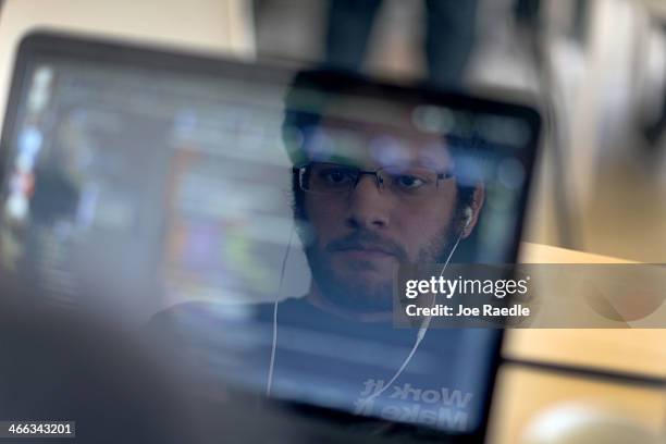 Miguel Chateloin uses a computer to write code that would allow people living in Cuba to use email to post to blogs during the Hackathon for Cuba...