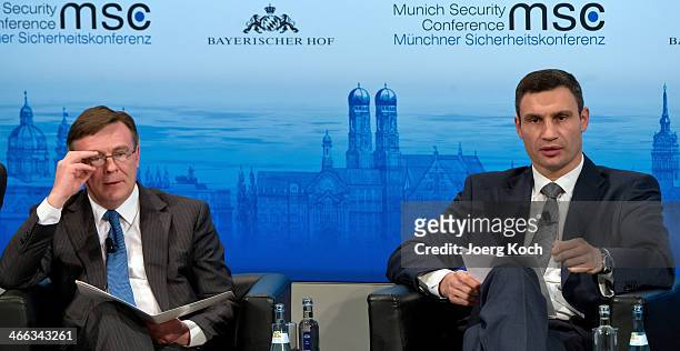 Leonid Kozhara, Ukrainian Minister for Foreign Affairs and head of the Ukrainian UDAR party Vitali Klitschko sit next to each other during a panel...