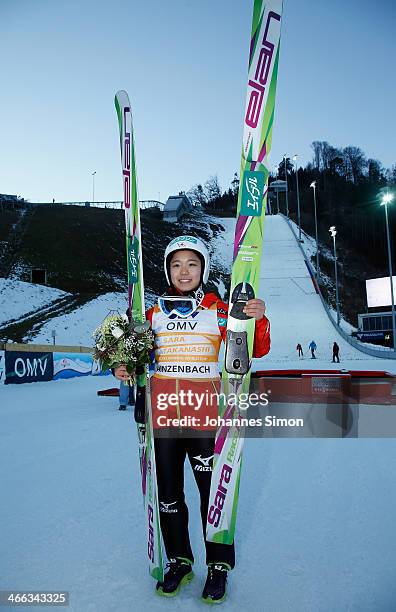 Sara Takanashi of Japan poses after the winning ceremony of the Normal Hill Individual FIS Women's Ski Jumping World Cup competition at Hinzenbach...