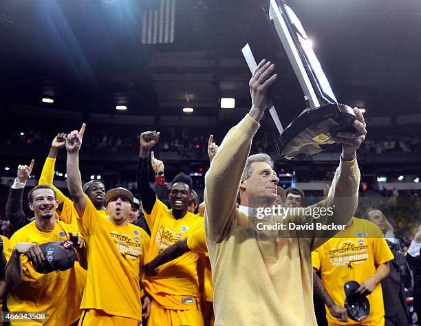 Head coach Larry Shyatt of the Wyoming Cowboys holds the championship trophy after defeating the San Diego State Aztecs during the championship game...