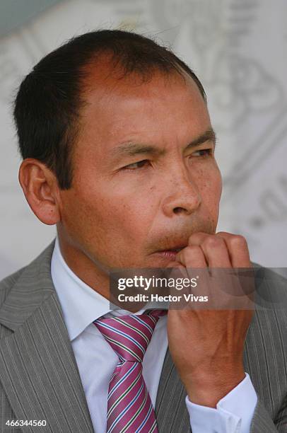 Jose Guadalupe Cruz coach of Puebla watchs the actions during a match between Puebla and Chivas as part of 10th round Clausura 2015 Liga MX at BUAP...