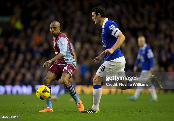 Fabian Delph of Aston Villa is challenged by Gareth Barry of Everton during the Barclays Premier League match between Everton and Aston Villa at...