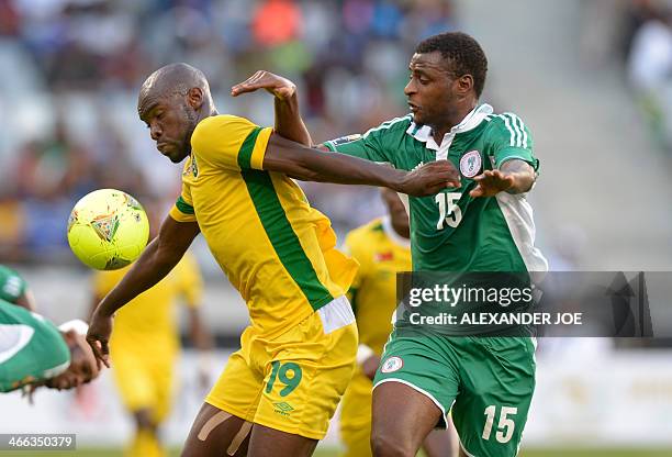 Zimbabwean player Simba Sithole fights off Nigerian player Umar Zango during the 2014 African Nations Championship football match between Zimbabwe...