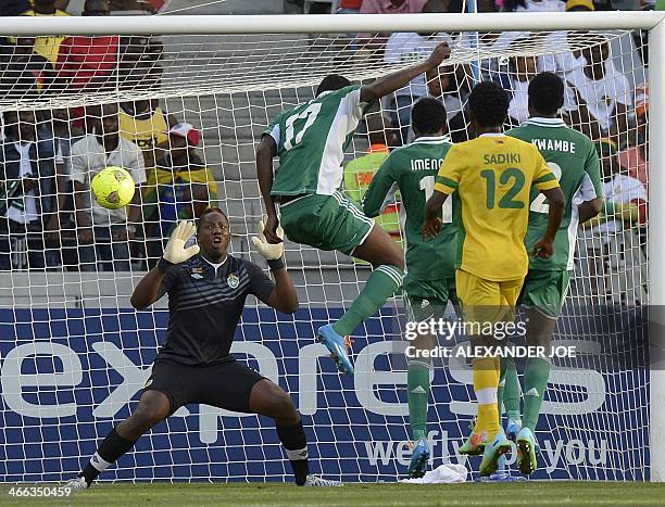 Nigerian player Chinoso Christian Obiozor scores a goal against Zimbabwean goalkeeper George Chigova during the 2014 African Nations Championship...