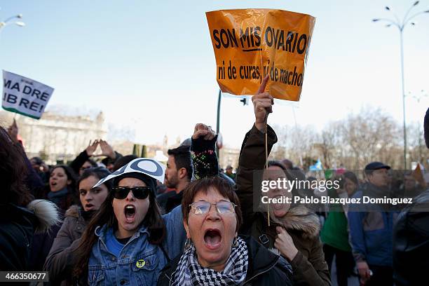 Protesters shout slogans and hold a placard reading 'they are my ovaries, nor of priest, nor of males' during a pro-abortion protest in Neptuno...