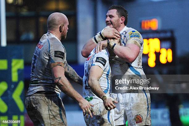 Haydn Thomas of Exeter Chiefs celebrates his try with teammates James Scaysbrook and James Phillips and during the LV= Cup match between Worcester...