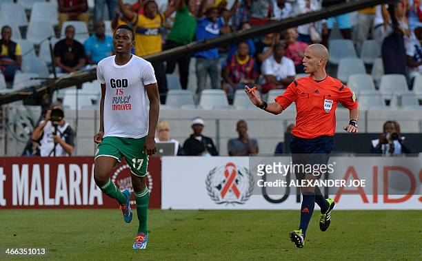 Nigerian player Chinonso Christian Obiozor celebrates after scoring a goal against Zimbabwe by removing his jersey and revealing a tee-shirt reading...