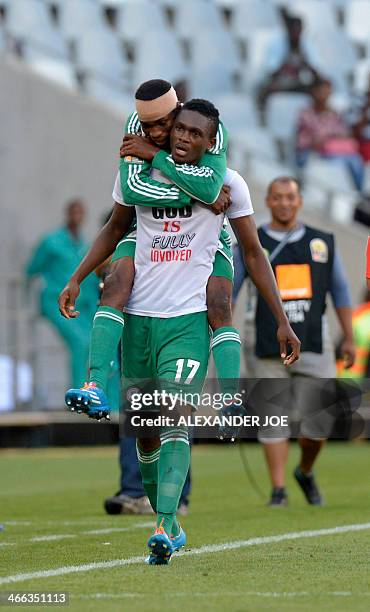 Nigerian player Chinonso Christian Obiozor celebrates with teammate Odunlami Kunle after scoring a goal against Zimbabwe during the 2014 African...