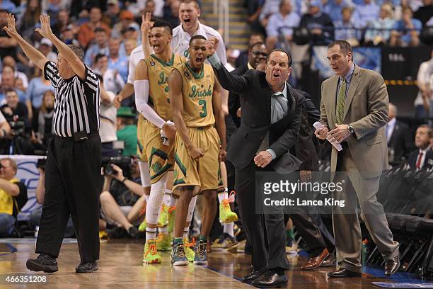 Head Coach Mike Brey of the Notre Dame Fighting Irish and his players react against the North Carolina Tar Heels during the finals of the 2015 Men's...