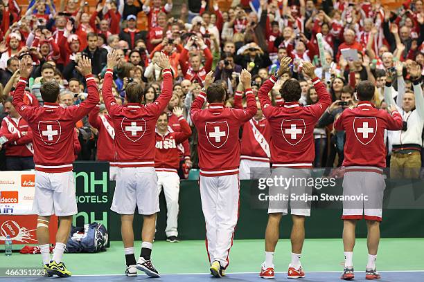 Marco Chiudinelli, Michael Lammer, Stanislas Wawrinka, Roger Federer and team captain Severin Luthi celebrate victory against Serbia after their...