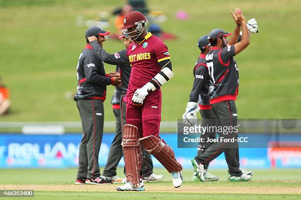 Marlon Samuels of the West Indies walks off the pitch after being caught by Andri Berenger of the UAE off the bowling of Manjula Guruge during the...
