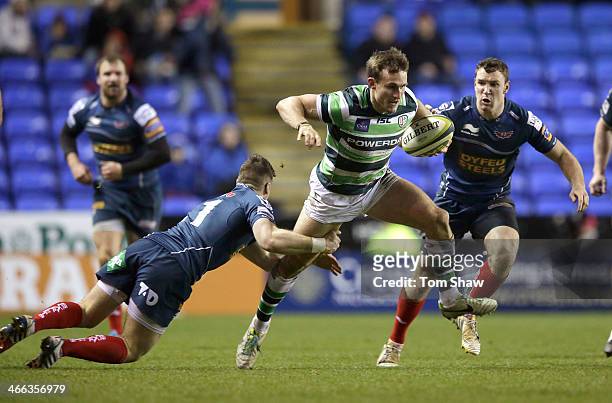 Andrew Fenby of London Irish is tackled during the LV= Cup Match between London Irish and Scarlets at the Madejski Stadium on February 1, 2014 in...