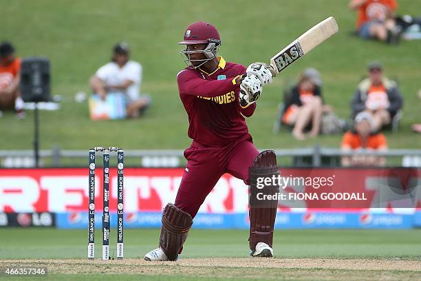 West Indies batsman Johnson Charles hits the ball during the Pool B 2015 Cricket World Cup match between West Indies and United Arab Emirates at...