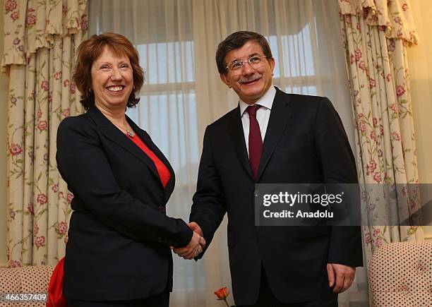 Turkey's Foreign Minister Ahmet Davutoglu shakes hand European Union High Representative for Foreign Affairs and Security Policy Catherine Ashton at...