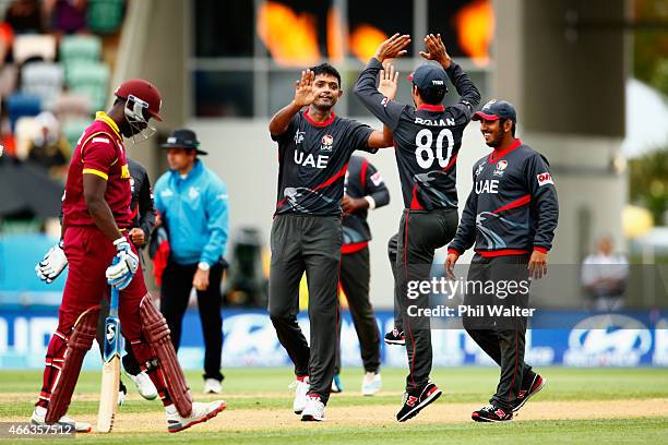 Amjad Javed of the United Arab Emirates celebrates his wicket of Andre Russell of West Indies during the 2015 ICC Cricket World Cup match between the...