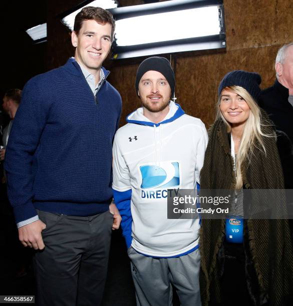Eli Manning, Aaron Paul and Lauren Parsekian attend the DirecTV Beach Bowl at Pier 40 on February 1, 2014 in New York City.