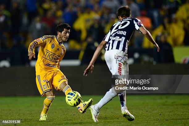 Damian Alvarez of Tigres kicks the ball as Jurgen Damm of Pachuca tries to block during a match between Tigres UANL and Pachuca as part of 10th round...