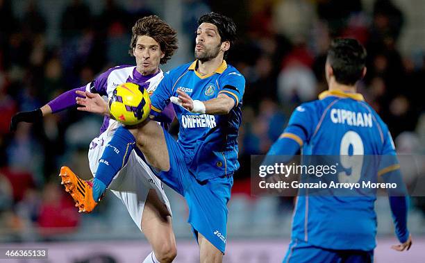 Angel Lafita of Getafe CF competes for the ball with Alvaro Rubio of Real Valladolid CFduring the La Liga match between Getafe CF and Real Valladolid...